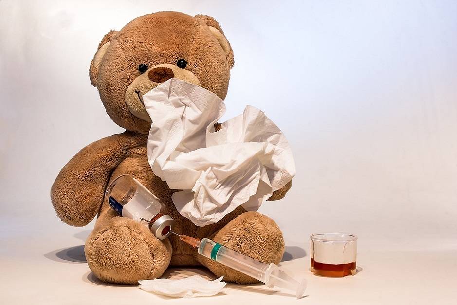 Stuffed teddy bear with tissue, medicine, and shot