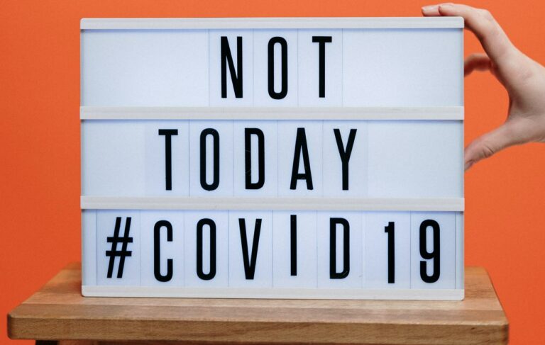 Black words on sign that says "Not Today COVID19"